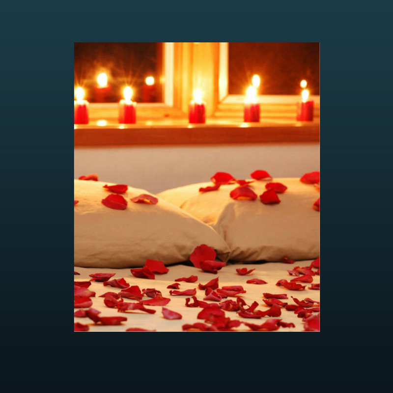 rose petals on bed with candles